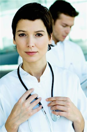 simsearch:6108-05860384,k - Portrait of a female doctor standing with a stethoscope around her neck Foto de stock - Sin royalties Premium, Código: 6108-05860351
