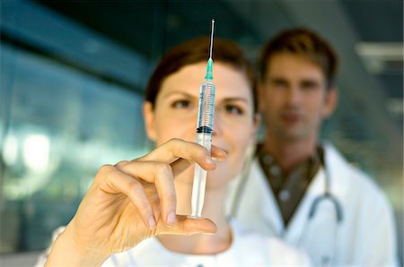 doctor syringe close up - Close-up of a female doctor holding a syringe Stock Photo - Premium Royalty-Free, Code: 6108-05860362