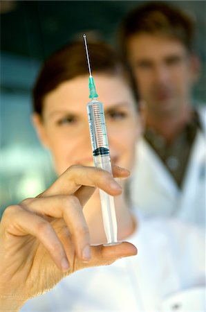 doctor syringe close up - Close-up of a female doctor holding a syringe Stock Photo - Premium Royalty-Free, Code: 6108-05860371