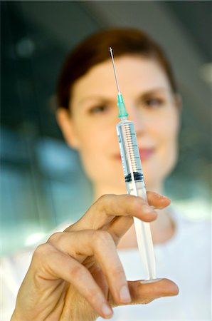 doctor syringe close up - Close-up of a female doctor holding a syringe Stock Photo - Premium Royalty-Free, Code: 6108-05860386