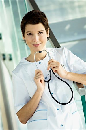simsearch:6108-05860439,k - Portrait of a female doctor holding a stethoscope Stock Photo - Premium Royalty-Free, Code: 6108-05860397