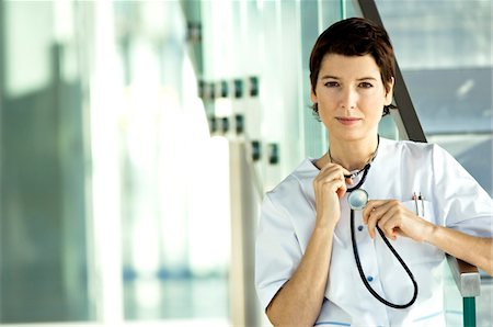 simsearch:6108-05860439,k - Portrait of a female doctor holding a stethoscope Stock Photo - Premium Royalty-Free, Code: 6108-05860394