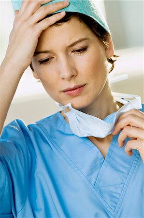 female surgeon close up - Close-up of a female doctor looking stressed Stock Photo - Premium Royalty-Free, Code: 6108-05860308