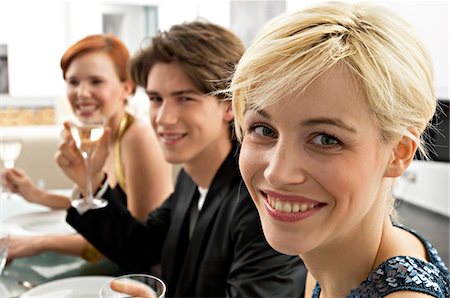 simsearch:6108-05858214,k - Two young women with a teenage boy at a dinner party Stock Photo - Premium Royalty-Free, Code: 6108-05860641
