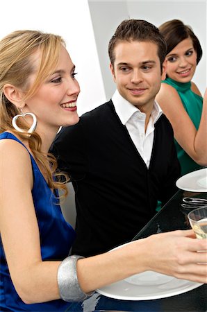 simsearch:6108-05858214,k - Young man with two young women at a dinner party Stock Photo - Premium Royalty-Free, Code: 6108-05860653