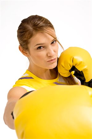 Portrait of a female boxer in a boxing stance Stock Photo - Premium Royalty-Free, Code: 6108-05860876