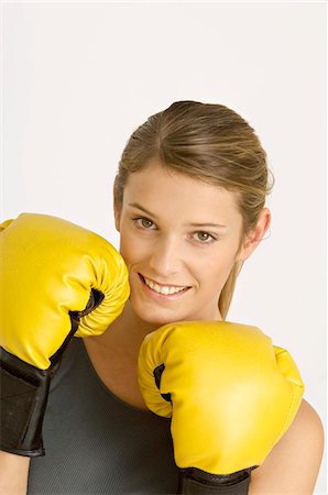 portrait of woman boxer - Portrait of a female boxer smiling Stock Photo - Premium Royalty-Free, Code: 6108-05860881