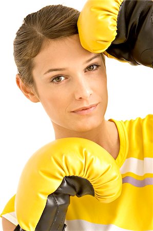 portrait of woman boxer - Portrait of a female boxer wearing boxing gloves Stock Photo - Premium Royalty-Free, Code: 6108-05860899