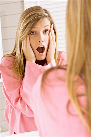 shocked hairs - Reflection of a young woman shocked and looking in mirror Stock Photo - Premium Royalty-Free, Code: 6108-05860959