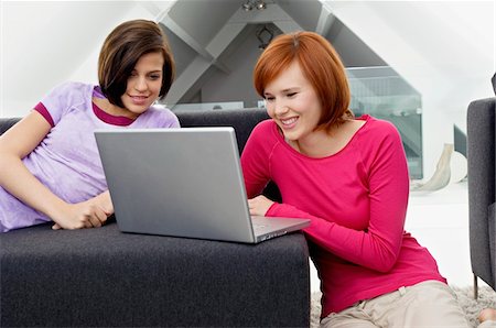 Two young women using a laptop Stock Photo - Premium Royalty-Free, Code: 6108-05861030