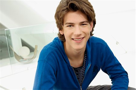 seated teenager - Portrait of a teenage boy smiling Stock Photo - Premium Royalty-Free, Code: 6108-05861208