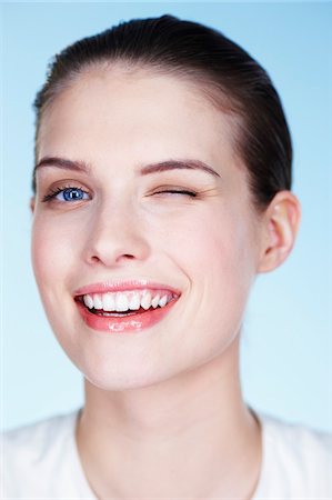 person winking - Portrait of young woman winking Stock Photo - Premium Royalty-Free, Code: 6108-05861343