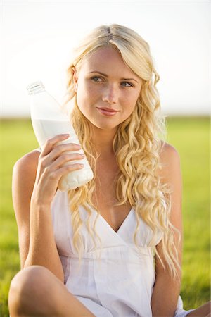 spring health - Young woman holding a milk bottle Stock Photo - Premium Royalty-Free, Code: 6108-05861366