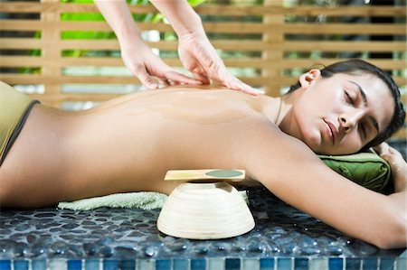 Woman receiving a back massage Stock Photo - Premium Royalty-Free, Code: 6108-05861684