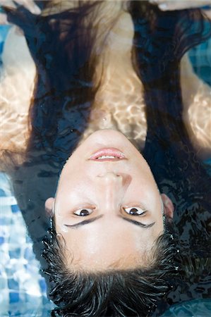 Woman in a swimming pool Stock Photo - Premium Royalty-Free, Code: 6108-05861688