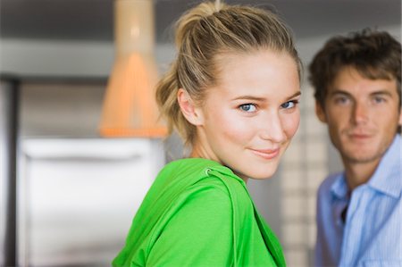 Portrait of a woman smiling with a man in the background Stock Photo - Premium Royalty-Free, Code: 6108-05861968
