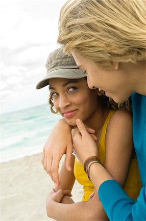 Teenage boy with a girl romancing on the beach Stock Photo - Premium Royalty-Free, Code: 6108-05862014