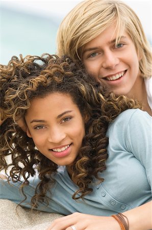 Portrait of a teenage boy with a girl on the beach Stock Photo - Premium Royalty-Free, Code: 6108-05862028