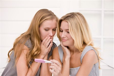 pregnant surprise - Two women looking at a pregnancy test stick Stock Photo - Premium Royalty-Free, Code: 6108-05862152