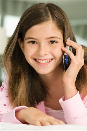 Portrait of a girl talking on a mobile phone Stock Photo - Premium Royalty-Free, Code: 6108-05862167