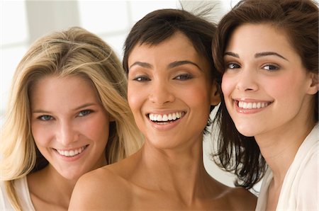 Portrait of three female friends smiling Stock Photo - Premium Royalty-Free, Code: 6108-05862137