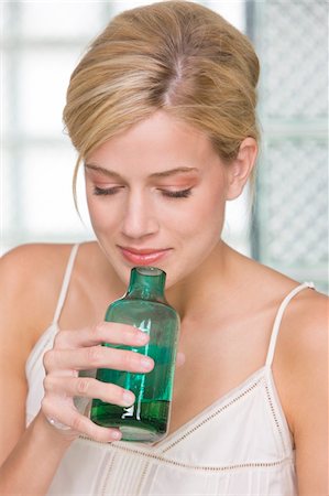 parfume bottle - Woman smelling aromatherapy oil Stock Photo - Premium Royalty-Free, Code: 6108-05862279