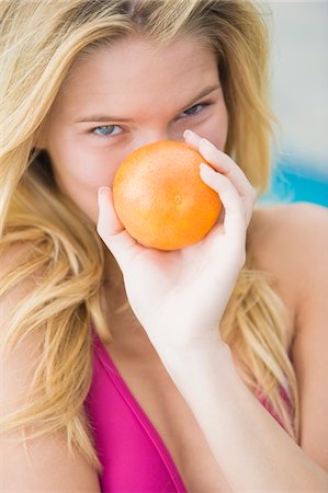 fruit eyes not children - Close-up of a woman holding an orange Stock Photo - Premium Royalty-Free, Code: 6108-05862389