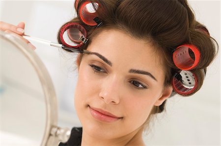 Close-up of a woman tweezing eyebrows Stock Photo - Premium Royalty-Free, Code: 6108-05862310