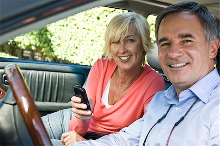 Couple in a car and smiling Stock Photo - Premium Royalty-Free, Code: 6108-05862774