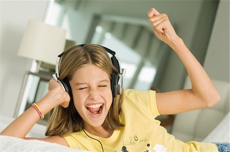 Girl listening to headphones Stock Photo - Premium Royalty-Free, Code: 6108-05862993