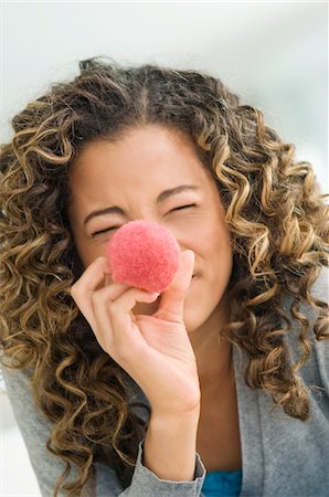 simsearch:6108-05873677,k - Close-up of a girl holding a blush brush in front of her face Stock Photo - Premium Royalty-Free, Code: 6108-05862903