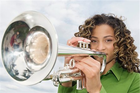 Portrait of a girl playing a trumpet Stock Photo - Premium Royalty-Free, Code: 6108-05862907