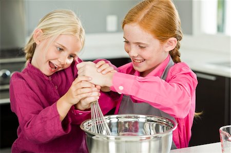Two girls cooking food in the kitchen Stock Photo - Premium Royalty-Free, Code: 6108-05863021