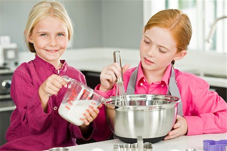 simsearch:6108-05857020,k - Two girls cooking food in the kitchen Stock Photo - Premium Royalty-Free, Code: 6108-05863034