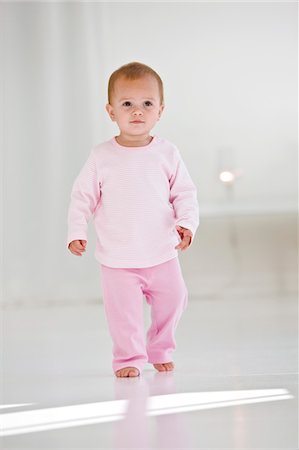 Baby girl walking on the floor Stock Photo - Premium Royalty-Free, Code: 6108-05863165