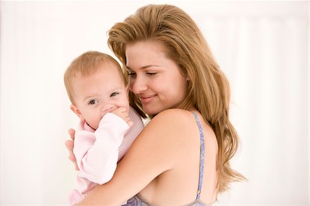 simsearch:6108-05863210,k - Woman holding her daughter Stock Photo - Premium Royalty-Free, Code: 6108-05863176