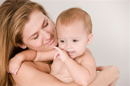 Close-up of a woman carrying her daughter Stock Photo - Premium Royalty-Free, Code: 6108-05863196