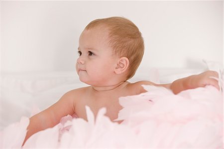 soft closeup - Baby girl playing with feathers Stock Photo - Premium Royalty-Free, Code: 6108-05863137