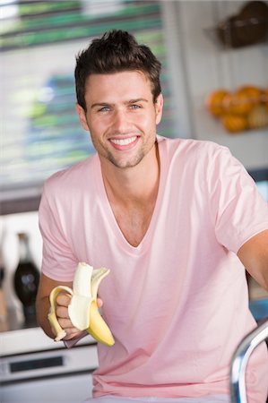 Portrait of a man eating a banana Stock Photo - Premium Royalty-Free, Code: 6108-05863247