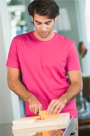 simsearch:6108-05863298,k - Man cutting cheese slices Stock Photo - Premium Royalty-Free, Code: 6108-05863249