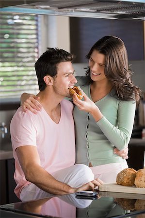 feeding food to lover images - Woman feeding breakfast to a man Stock Photo - Premium Royalty-Free, Code: 6108-05863250