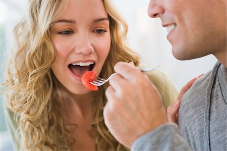 feeding food to lover images - Man feeding strawberry to his wife Stock Photo - Premium Royalty-Free, Code: 6108-05863252