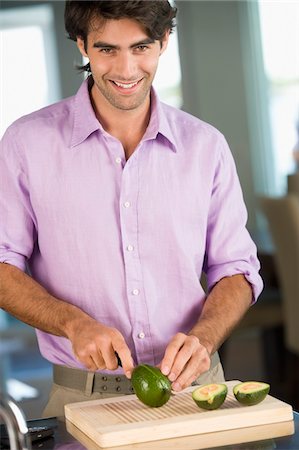 simsearch:6108-05857020,k - Man cutting avocado and smiling Stock Photo - Premium Royalty-Free, Code: 6108-05863283