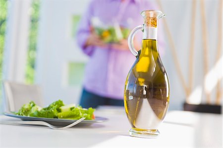 simsearch:6108-05865420,k - Salad oil with a plate of salad on a dining table Stock Photo - Premium Royalty-Free, Code: 6108-05863304