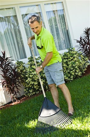 Man raking the lawn Stock Photo - Premium Royalty-Free, Code: 6108-05863313