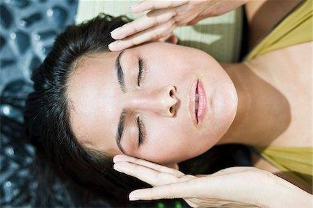 Close-up of a woman rubbing her temples Stock Photo - Premium Royalty-Free, Code: 6108-05863492