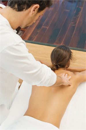 person lying back above view - Man receiving a back massage from a massage therapist Stock Photo - Premium Royalty-Free, Code: 6108-05863497