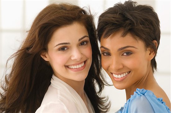 Portrait of two female friends smiling Stock Photo - Premium Royalty-Free, Image code: 6108-05863567
