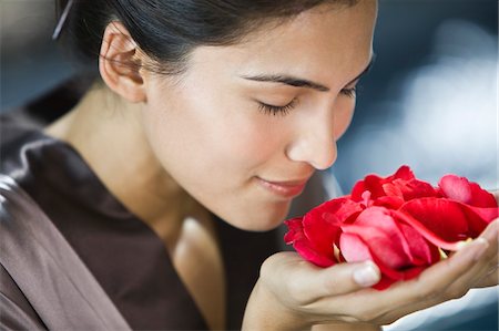 Woman smelling rose flowers Stock Photo - Premium Royalty-Free, Code: 6108-05863537