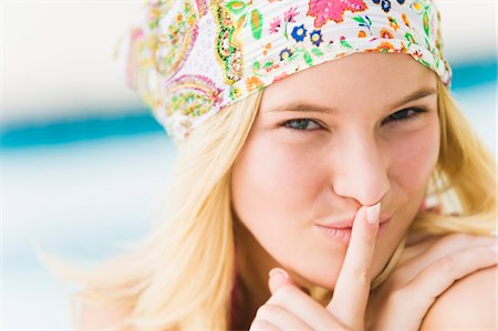 quiet and secret - Portrait of a woman with finger on lips Stock Photo - Premium Royalty-Free, Code: 6108-05863757